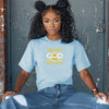 Trust God With Tomorrow T-Shirt modeled by a woman sitting, showcasing its encouraging design and comfort fit.