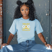 Trust God With Tomorrow T-Shirt modeled by a woman sitting, showcasing its encouraging design and comfort fit.
