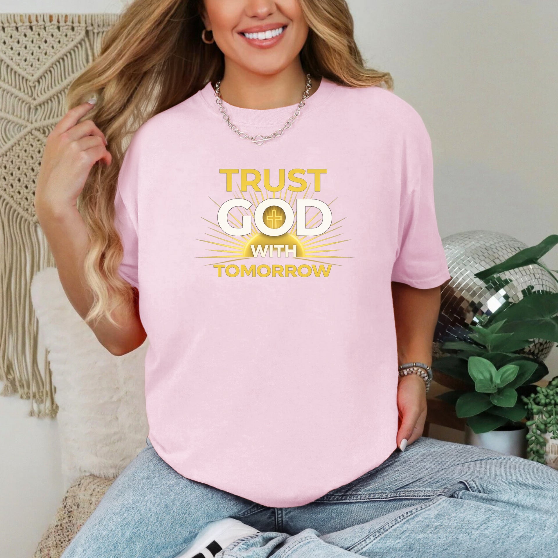 Trust God With Tomorrow T-Shirt displayed on a smiling woman wearing a pink t-shirt, embodying faith and confidence.