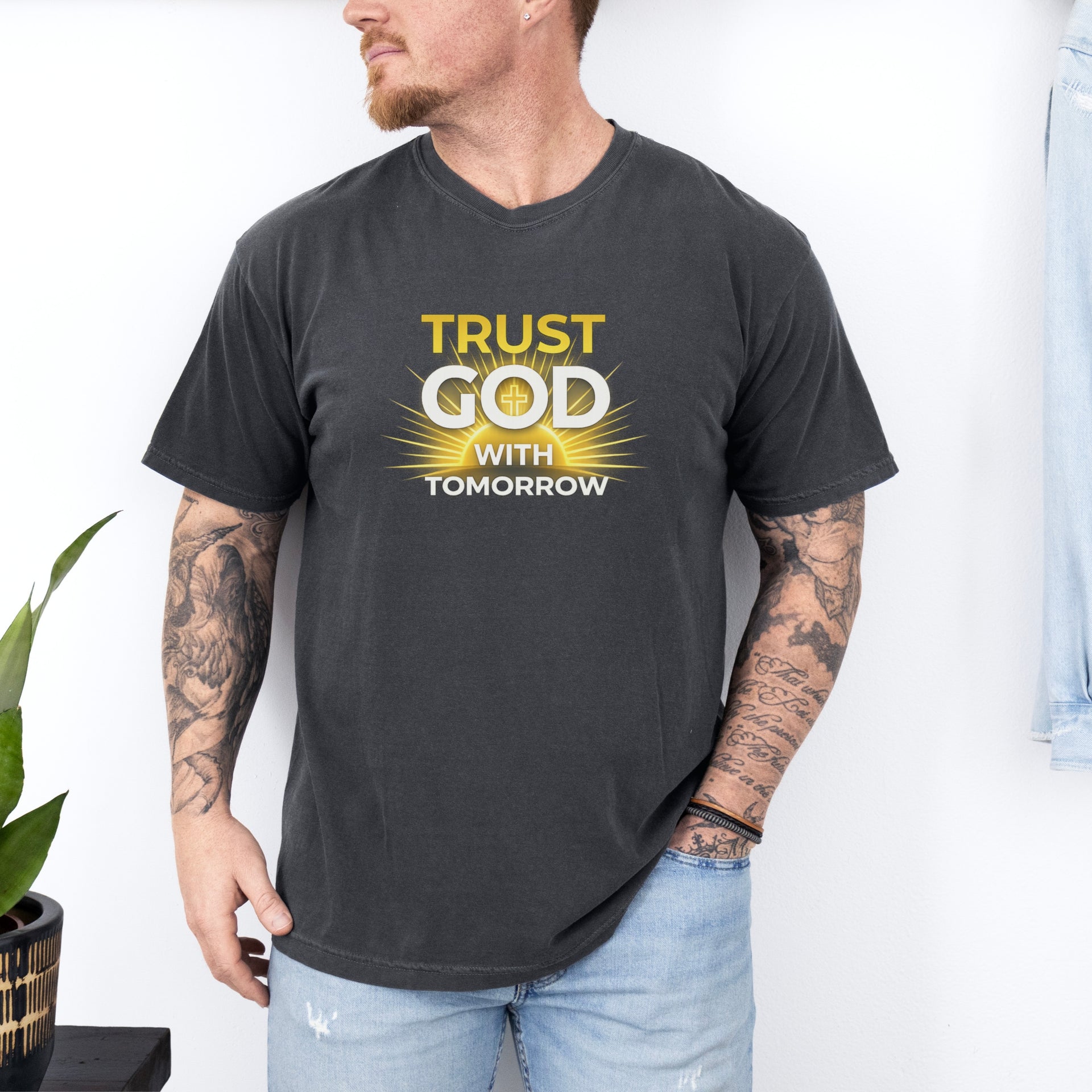 Man wearing Trust God With Tomorrow T-Shirt, featuring bold inspirational text and a stylish design.