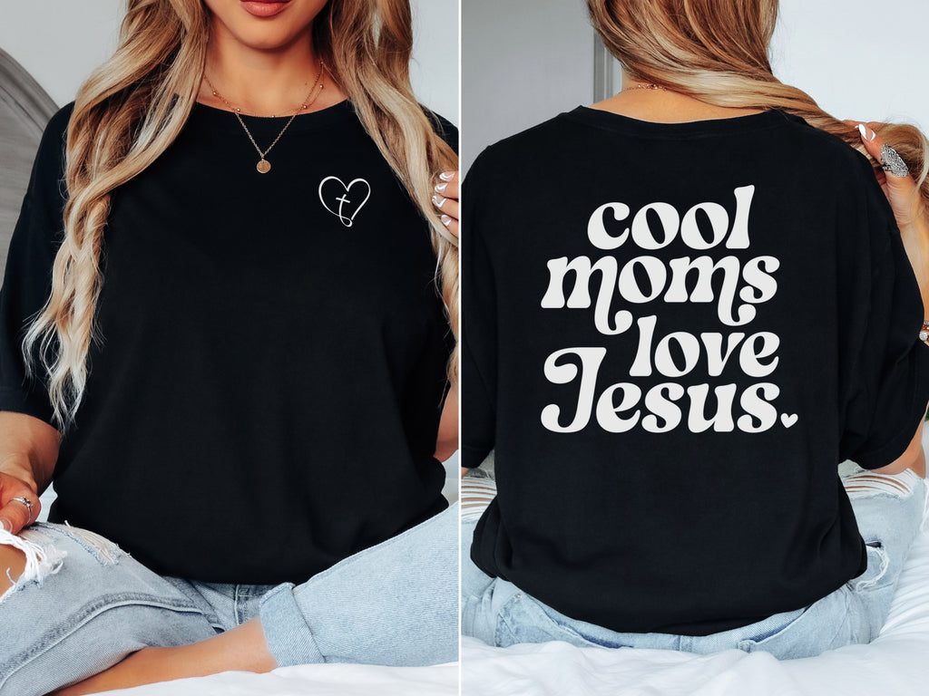Model wearing a Cool Moms Love Jesus T Shirt showcasing heart design and trendy text on back.