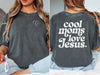 Model wearing a Cool Moms Love Jesus T Shirt featuring heart design on front and bold text on back.