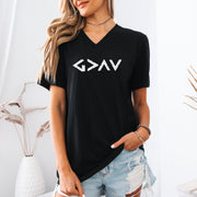 Model wearing God Is Greater Than Highs And Lows V Neck Tee in black with geometric design, styled casually.