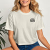 This Mama Prays Christian Crop Tee for Moms model smiling in casual outfit with plant background.