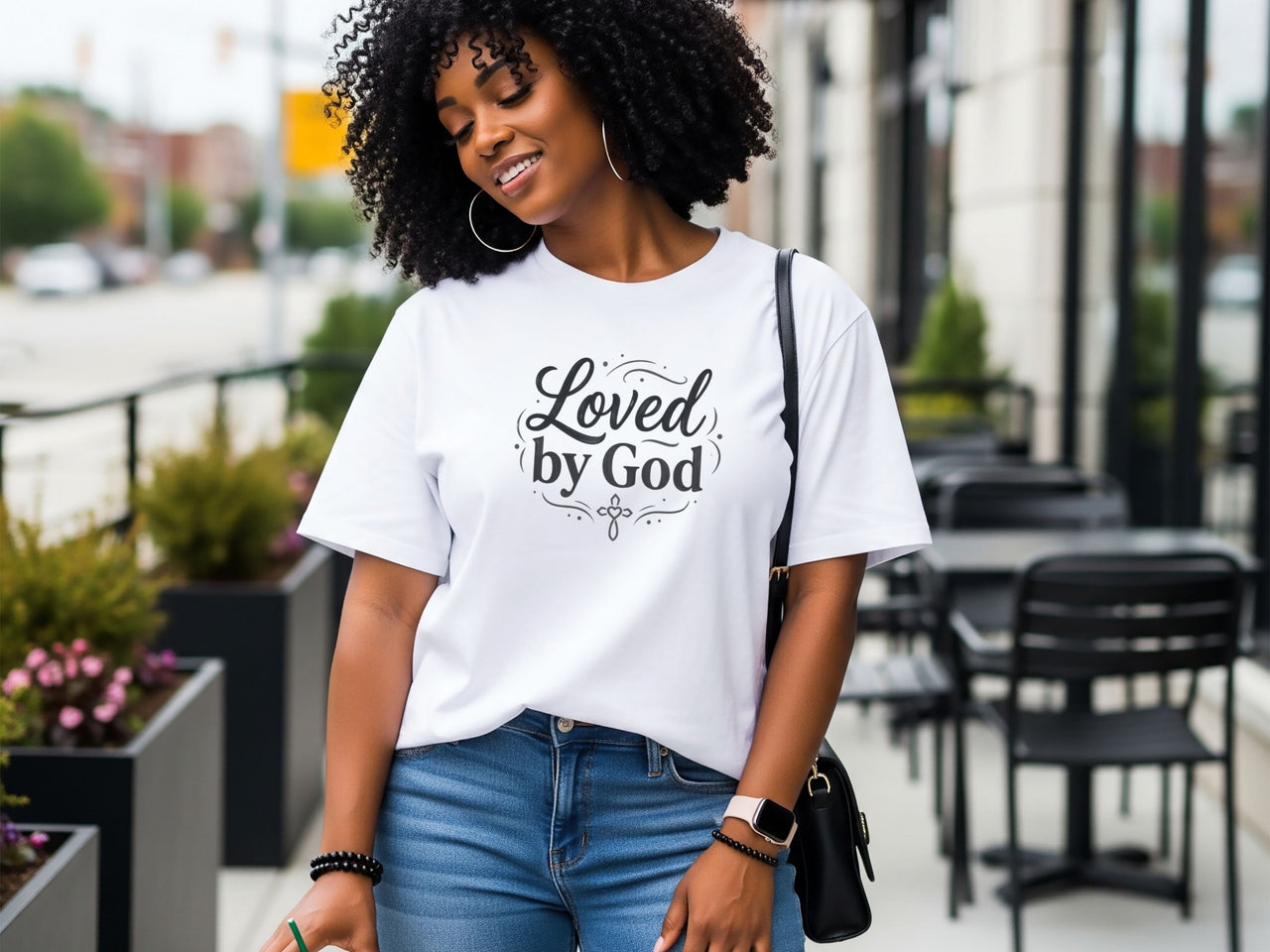Woman wearing a Loved by God T-Shirt outdoors, showcasing faith and comfort in casual style.