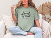 Model wearing a Loved by God T-Shirt in bay, perfect for casual outings and expressions of faith.