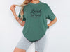 Woman wearing a Loved by God T-Shirt with a relaxed fit and stylish look.