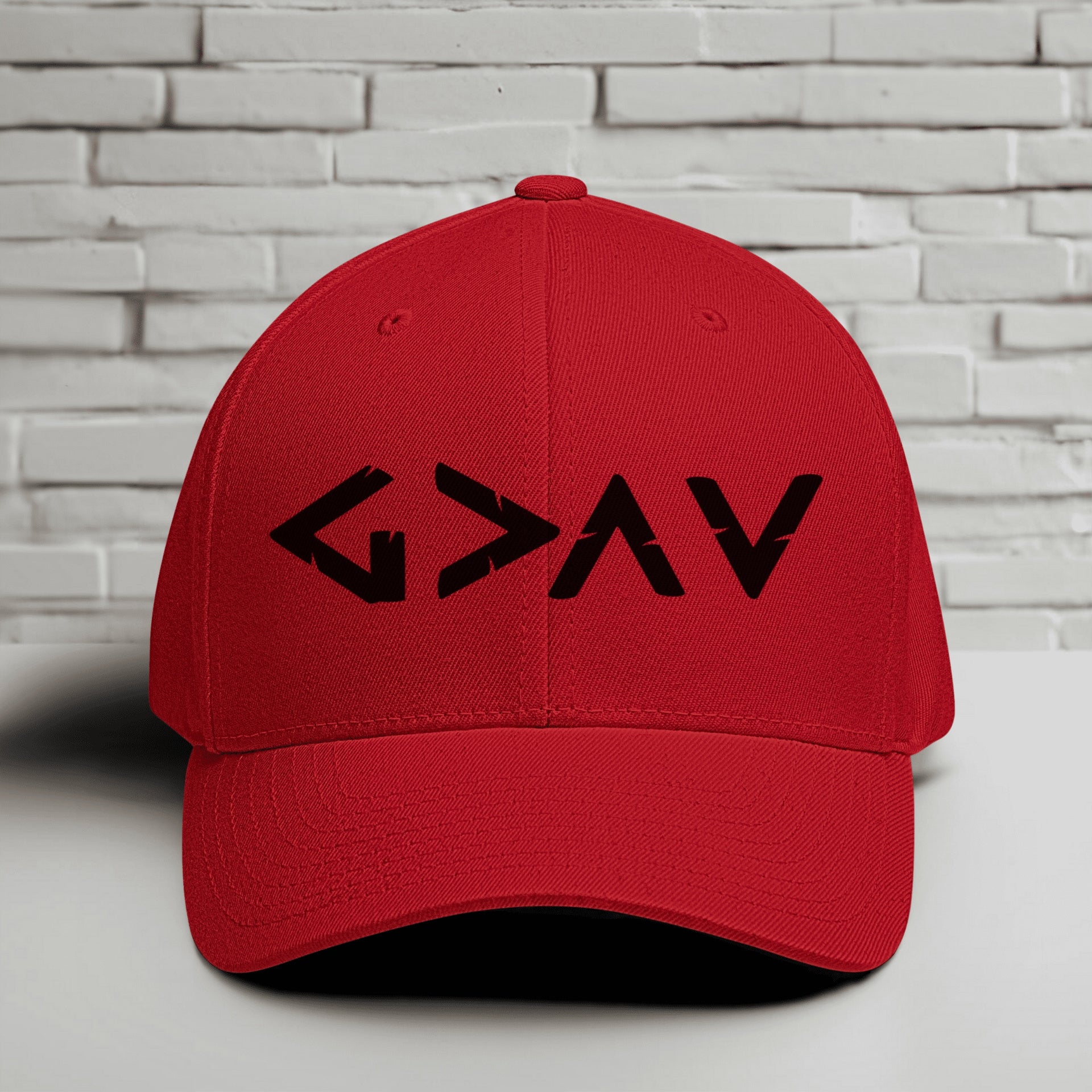 God is Greater Than Highs and Lows Embroidered Flexfit Hat in red with black logo design.