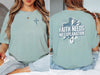 Model wearing a Faith Needs No Explanation T-Shirt featuring a cross design in a bay color.