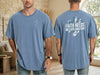 Front and back view of a Faith Needs No Explanation T-Shirt in blue worn by a man.