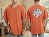 Model wearing a Faith Needs No Explanation T-Shirt in orange with cross detail on front and bold text on back.
