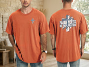 Model wearing a Faith Needs No Explanation T-Shirt in orange with cross detail on front and bold text on back.