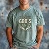 Model wearing Placed in God's Hands T-Shirt featuring hands graphic, symbolizing faith and trust in God.