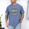 Man wearing a blue Placed in God's Hands T-Shirt with a motivational design featuring hands and the phrase.