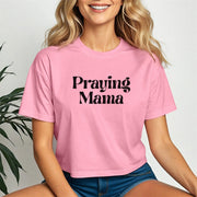 Woman wearing a pink Praying Mama Crop Tee, showcasing a stylish script design, perfect for faith-filled moms.