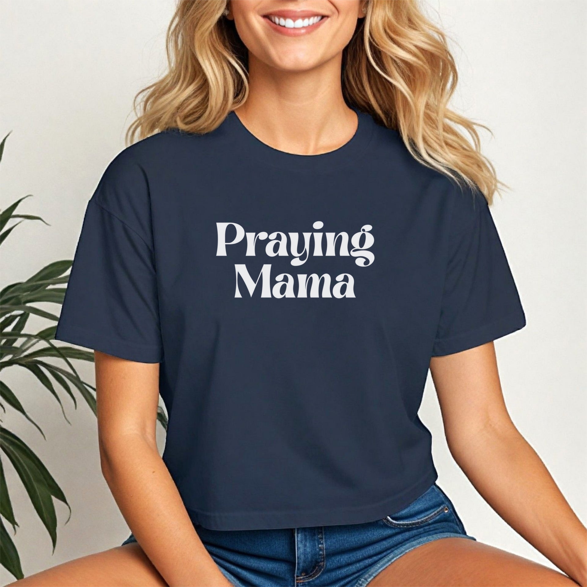 Praying Mama Crop Tee featuring a stylish script design worn by a smiling woman in a trendy cropped fit.