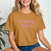 Model wearing a Praying Mama Crop Tee in camel color, showcasing a stylish script design for faith-filled moms.