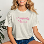 Woman wearing a Praying Mama Crop Tee with a trendy cropped fit and soft fabric, showcasing faith and style.