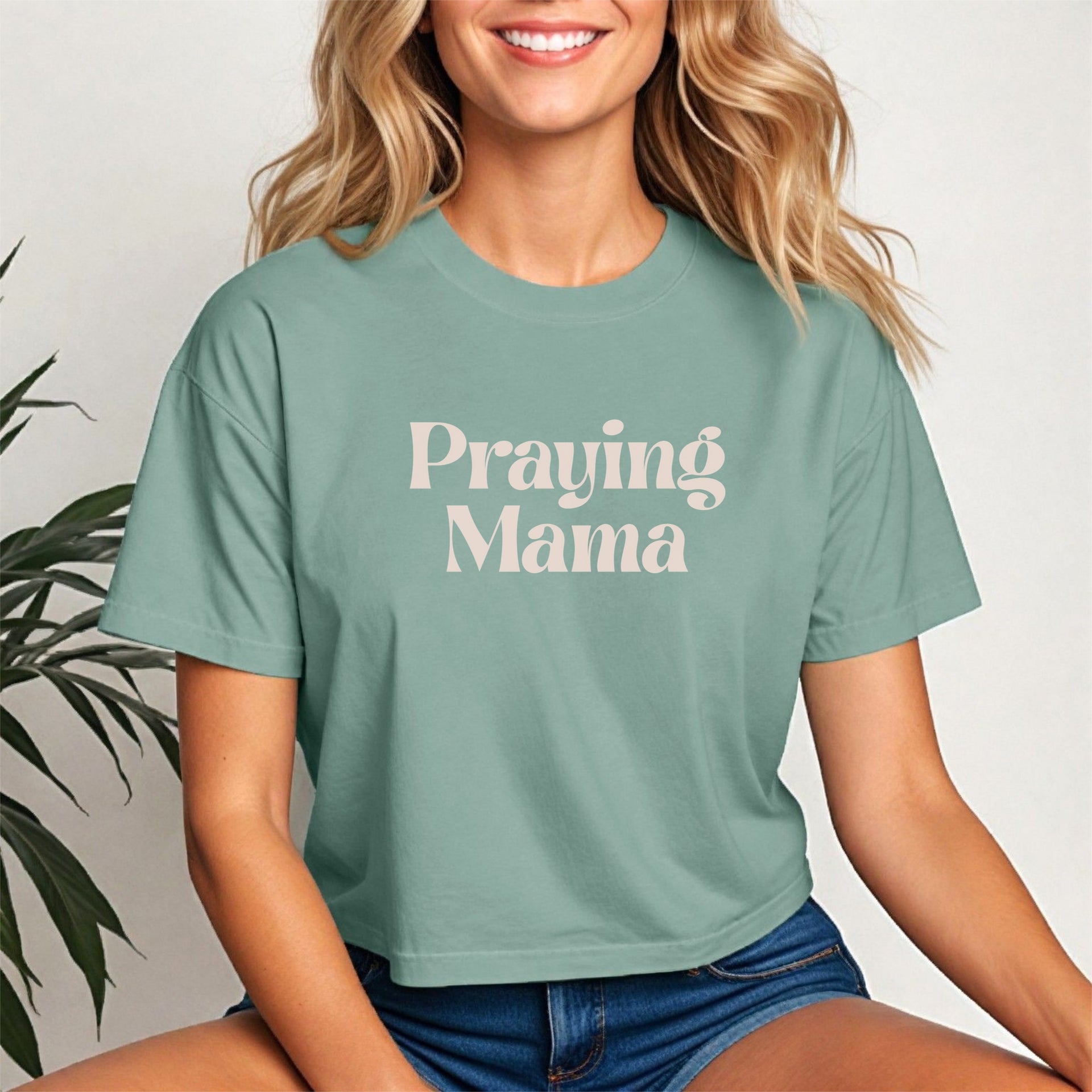 Praying Mama Crop Tee featuring a woman wearing a trendy cropped tee with script design, ideal for everyday wear.
