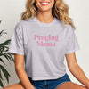 Woman wearing a light purple Praying Mama Crop Tee, showcasing a stylish script design for faith-filled moms.