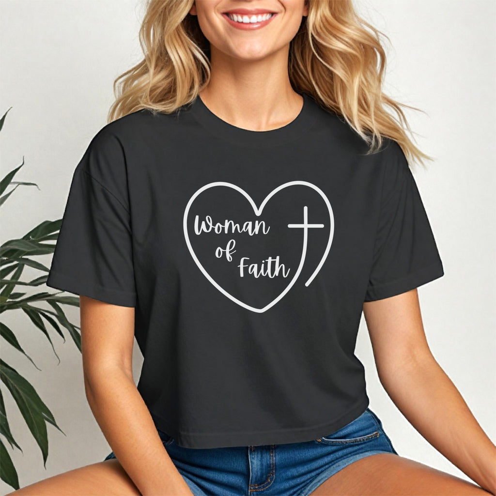 Woman Of Faith Heart Cross Crop Tee displayed by a woman, featuring heart and cross design in white on a black cropped tee.