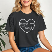Woman Of Faith Heart Cross Crop Tee displayed by a woman, featuring heart and cross design in white on a black cropped tee.
