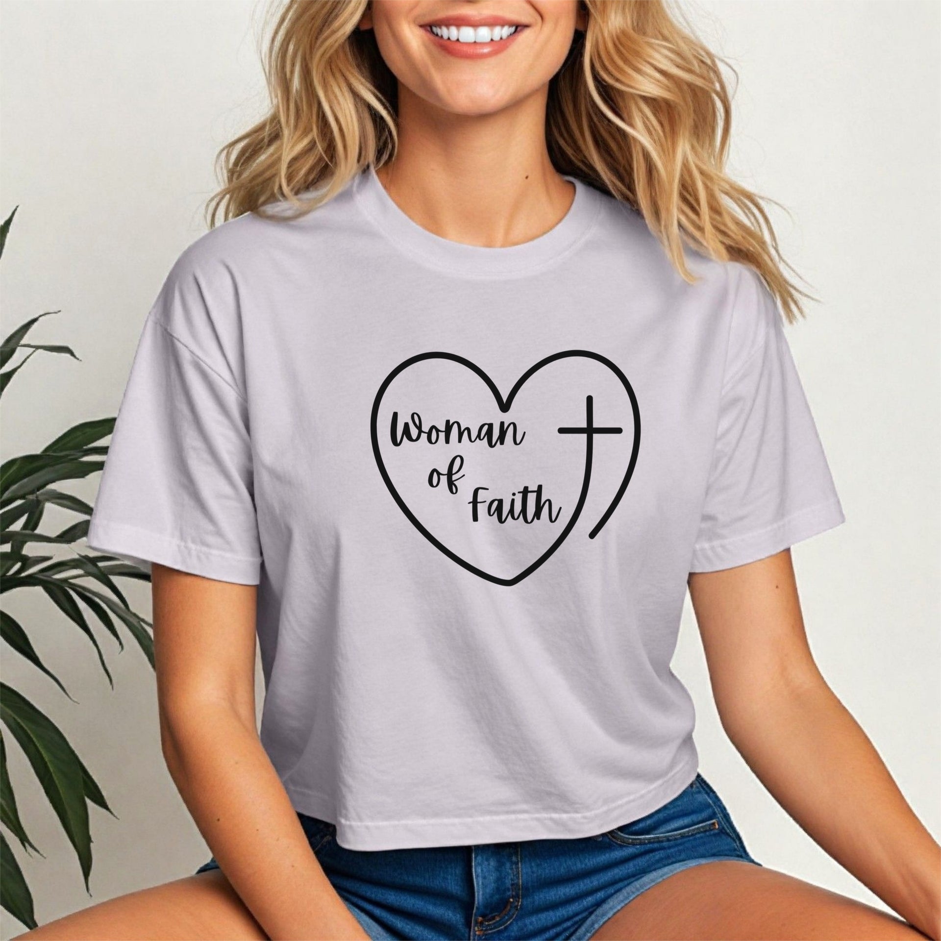 Woman Of Faith Heart Cross Crop Tee featuring a heart and cross design worn by a smiling woman.