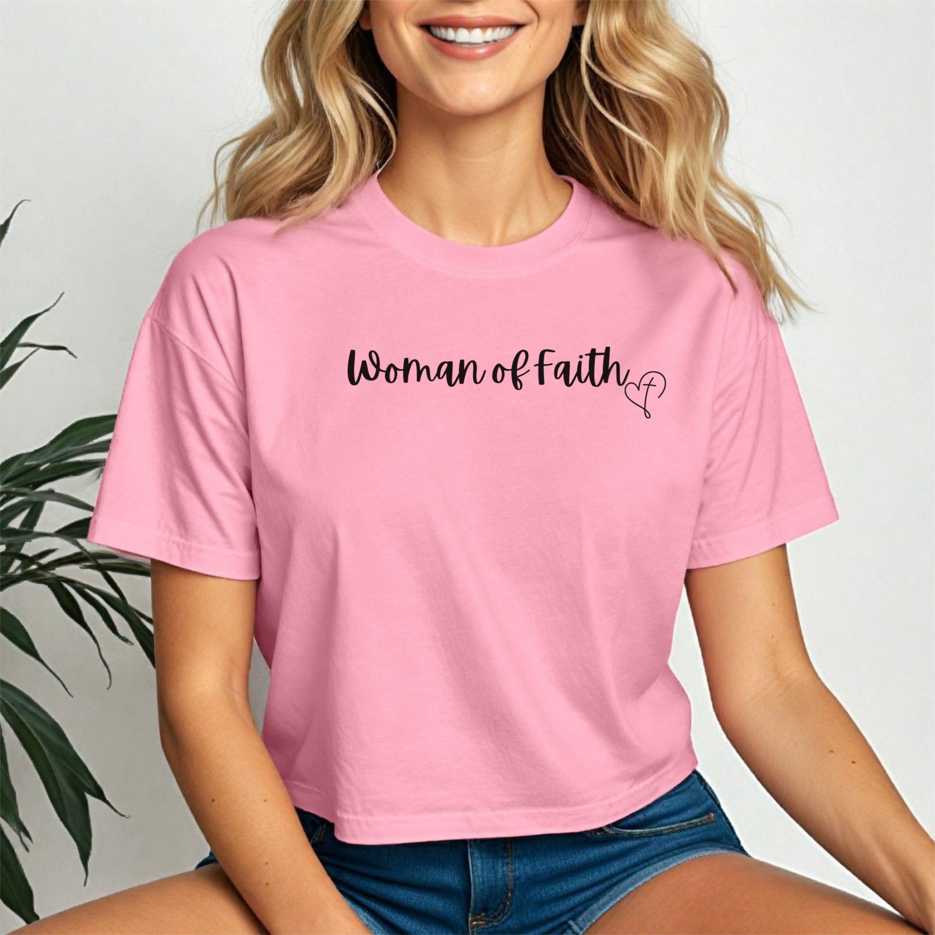 Model wearing a pink Woman Of Faith Crop Tee, showcasing its stylish design and comfortable fit.