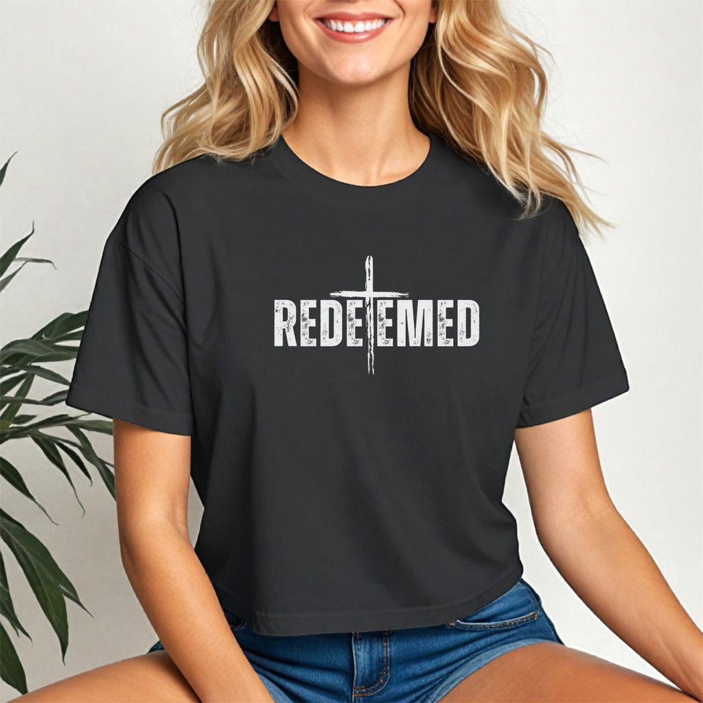 Redeemed Cross Graphic Crop Tee featuring a stylish cross design and trendy cropped fit on a model.