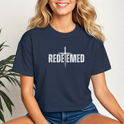 Model wearing a Redeemed Cross Graphic Crop Tee, showcasing a meaningful cross design in stylish cropped fit.