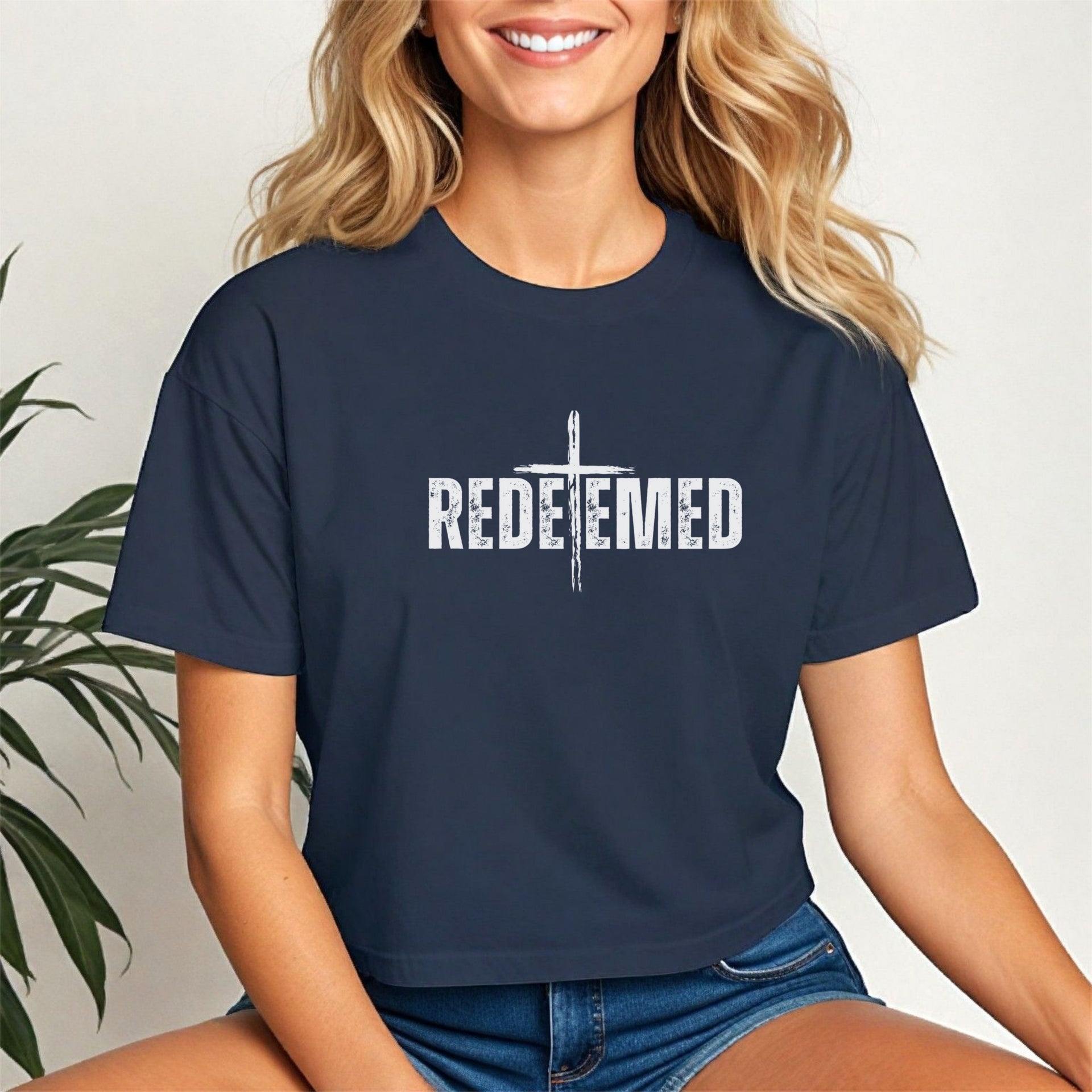 Model wearing a Redeemed Cross Graphic Crop Tee, showcasing a meaningful cross design in stylish cropped fit.