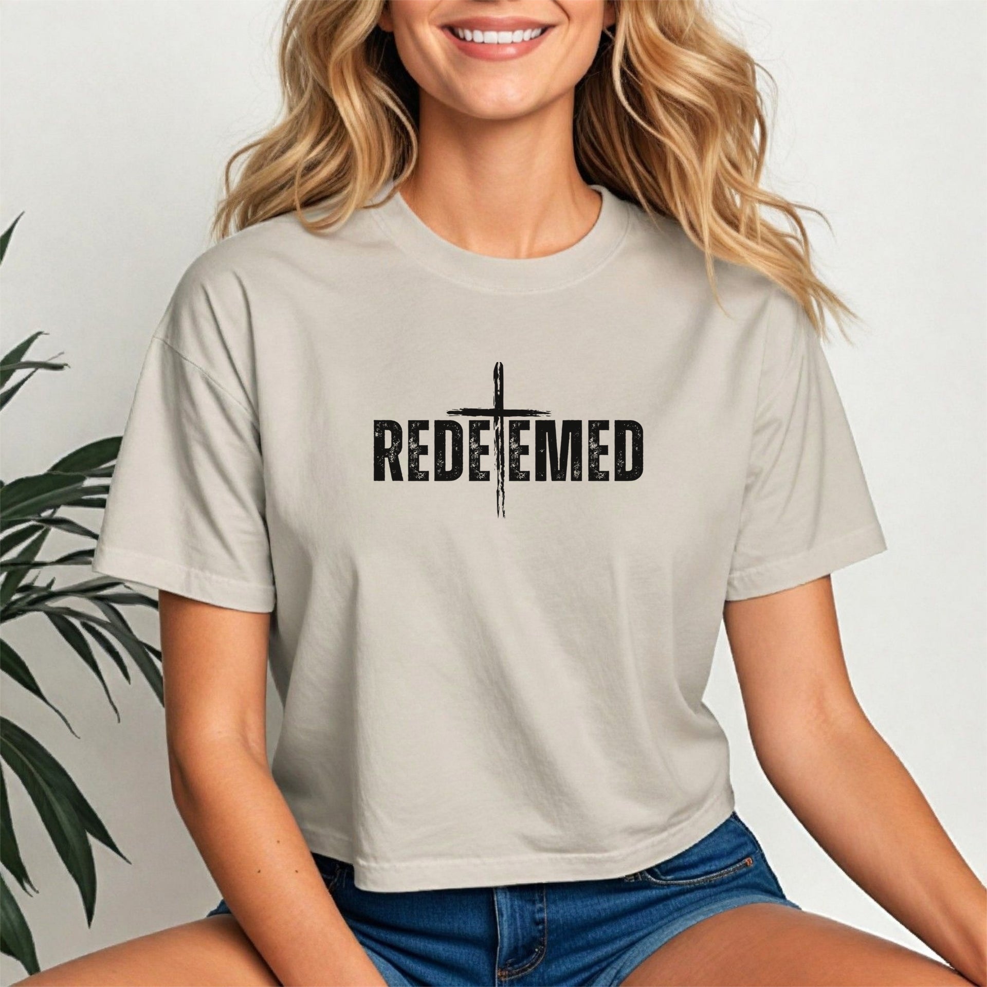 Redeemed Cross Graphic Crop Tee featuring a stylish design in soft fabric, perfect for everyday wear and expressing faith.