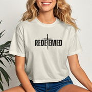 Redeemed Cross Graphic Crop Tee featuring a bold 'REDEEMED' design on a trendy cropped t-shirt.