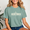 Model wearing the Redeemed Cross Graphic Crop Tee in sage, showcasing its trendy design and meaningful cross graphic.