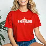 Woman wearing a red Redeemed Cross Graphic Crop Tee, showcasing a cross design.