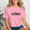 Woman wearing a pink Redeemed Cross Graphic Crop Tee featuring a cross design, perfect for casual and warm weather wear.