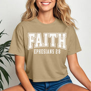 Faith Ephesians 2 8 Crop Tee worn by a smiling woman, featuring a trendy cropped design and scripture-inspired text.
