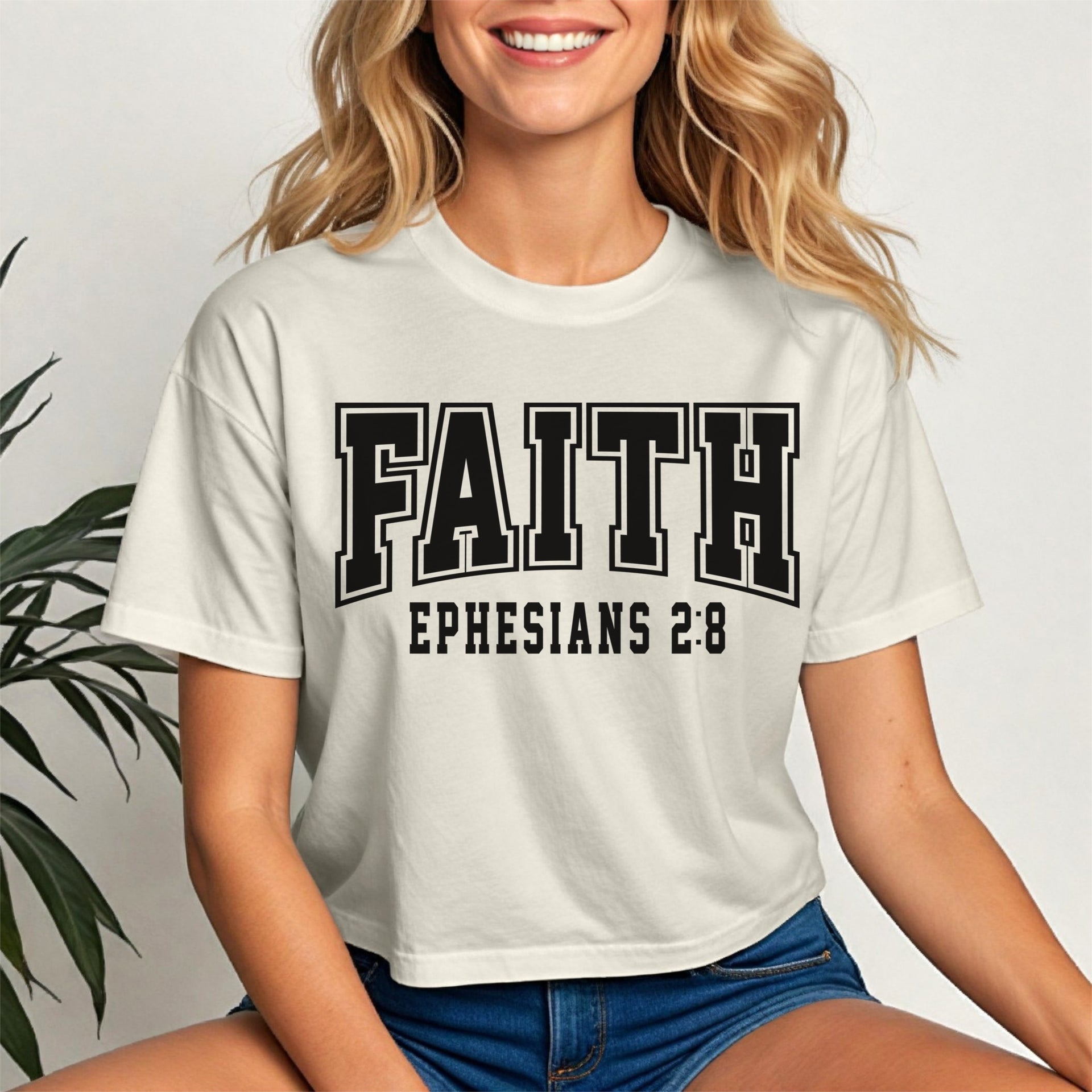 Faith Ephesians 2 8 Crop Tee worn by a smiling woman, emphasizing faith and style in a cropped design.