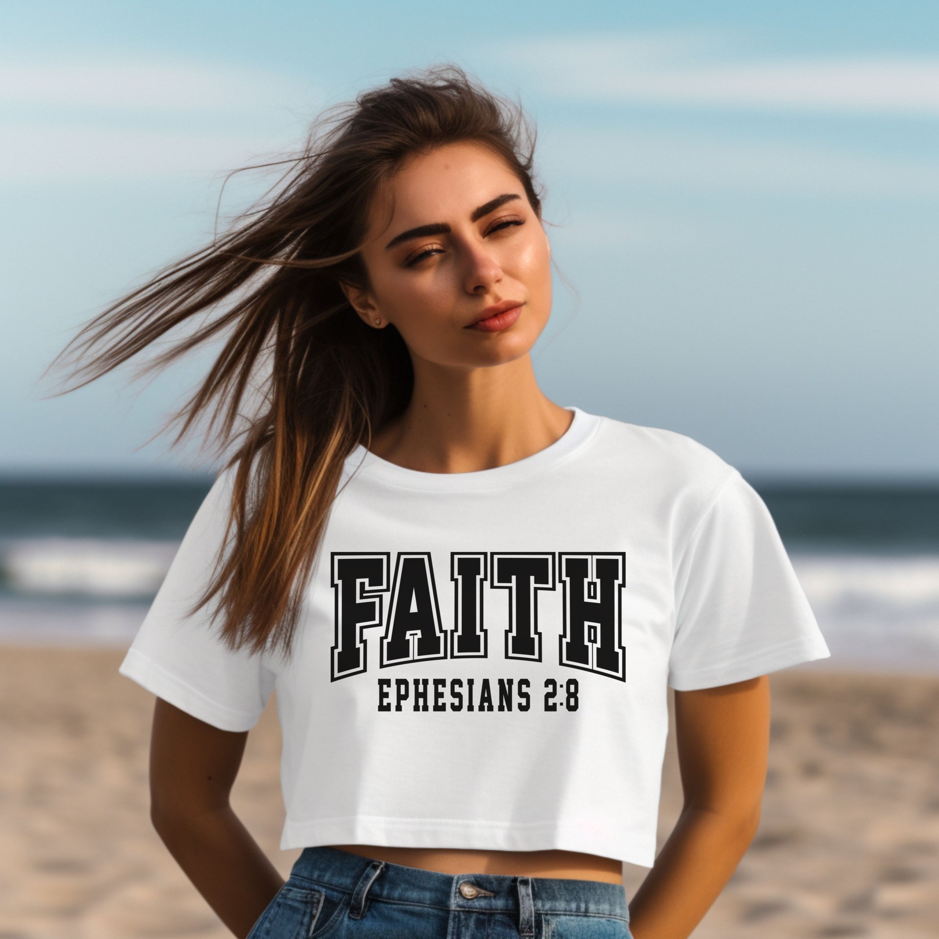 Faith Ephesians 2 8 Crop Tee displayed on a model at the beach, emphasizing style and faith.