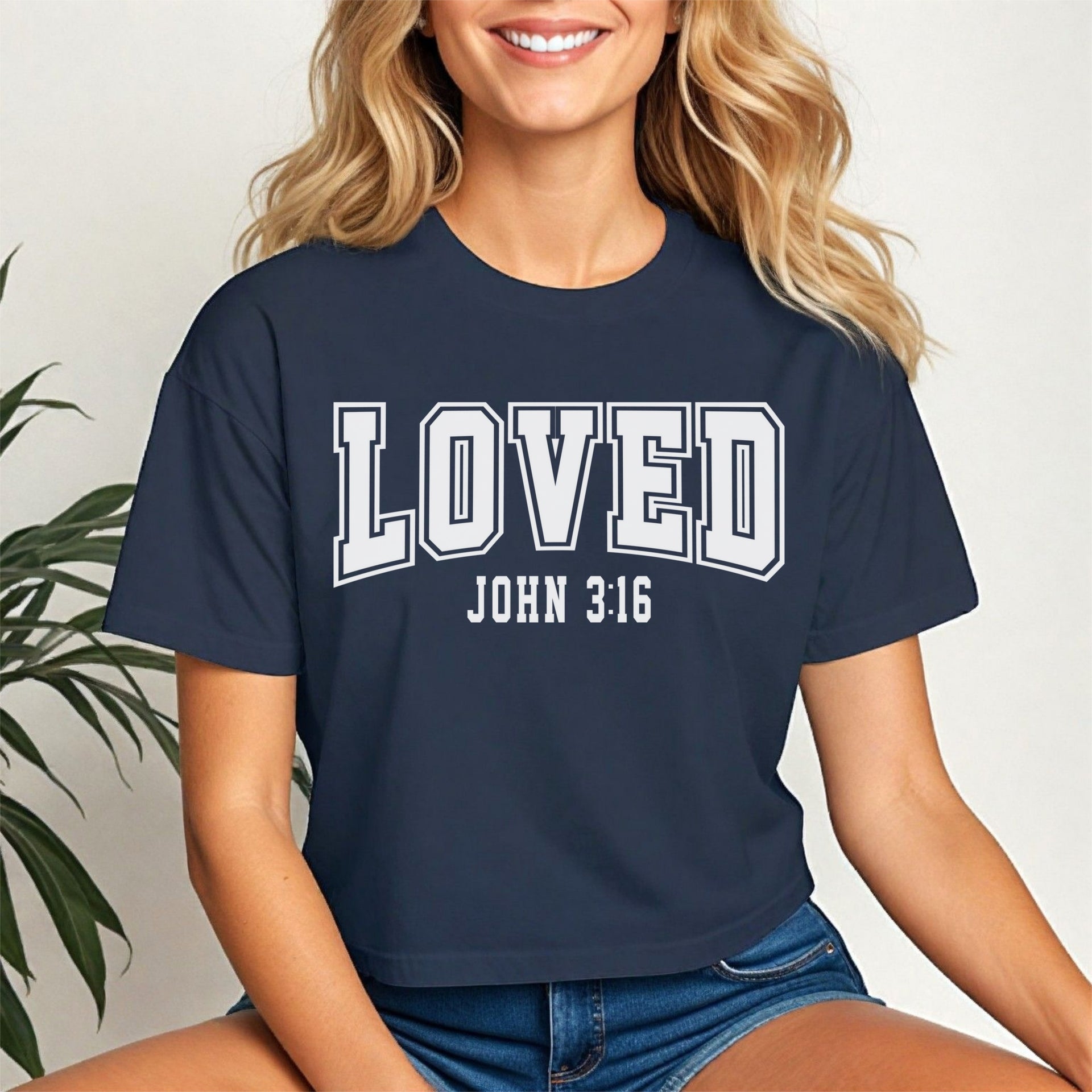 Loved John 3 16 Crop Tee worn by a smiling woman, showcasing its trendy style and inspirational message.