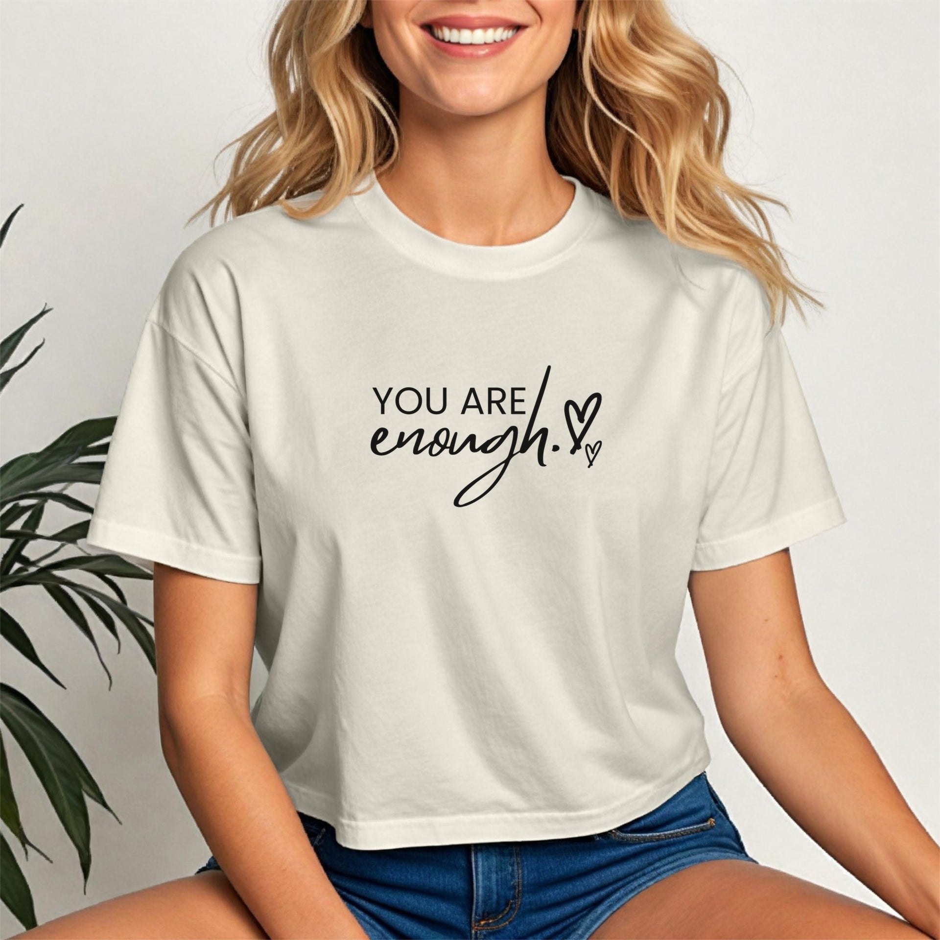 You Are Enough Script Heart Crop Tee worn by a smiling woman, featuring a soft script design and heart accent.