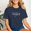 You Are Enough Script Heart Crop Tee displayed on a smiling woman wearing a navy cropped t-shirt with a script design.