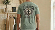 I Fight Demons Armor Of God Ephesians 6-11 Comfort Colors T Shirt displayed on a model's back in a cozy setting.