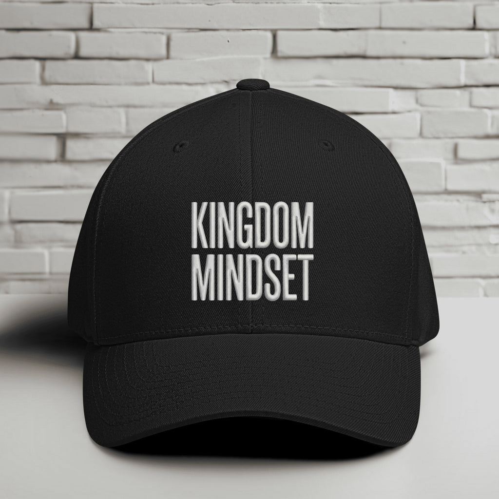 Kingdom Mindset Embroidered Flexfit Hat displayed against a brick wall background.