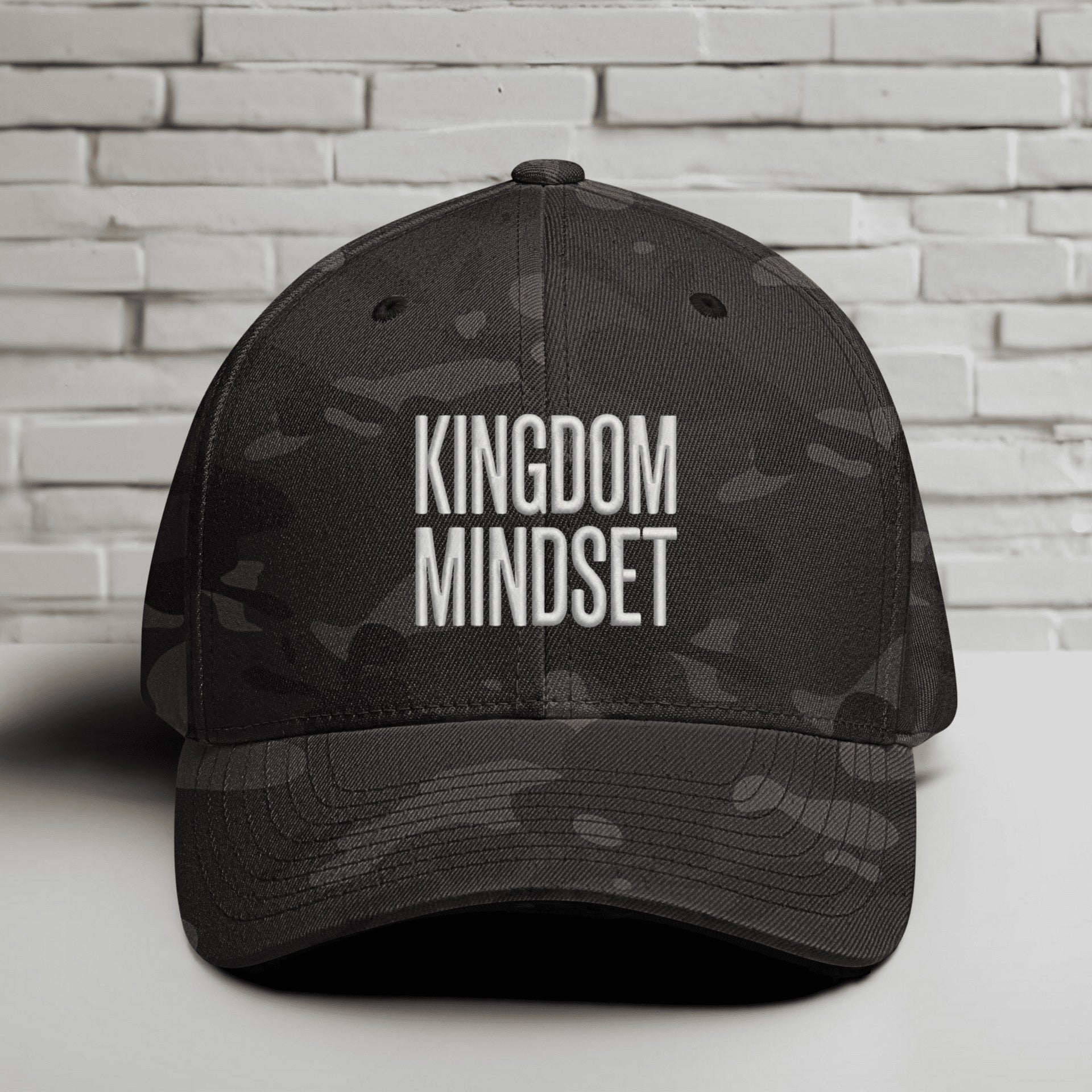 Front view of Kingdom Mindset Embroidered Flexfit Hat showcasing a stylish design on a dark background.