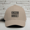 Kingdom Mindset Embroidered Flexfit Hat displayed against a brick wall background.