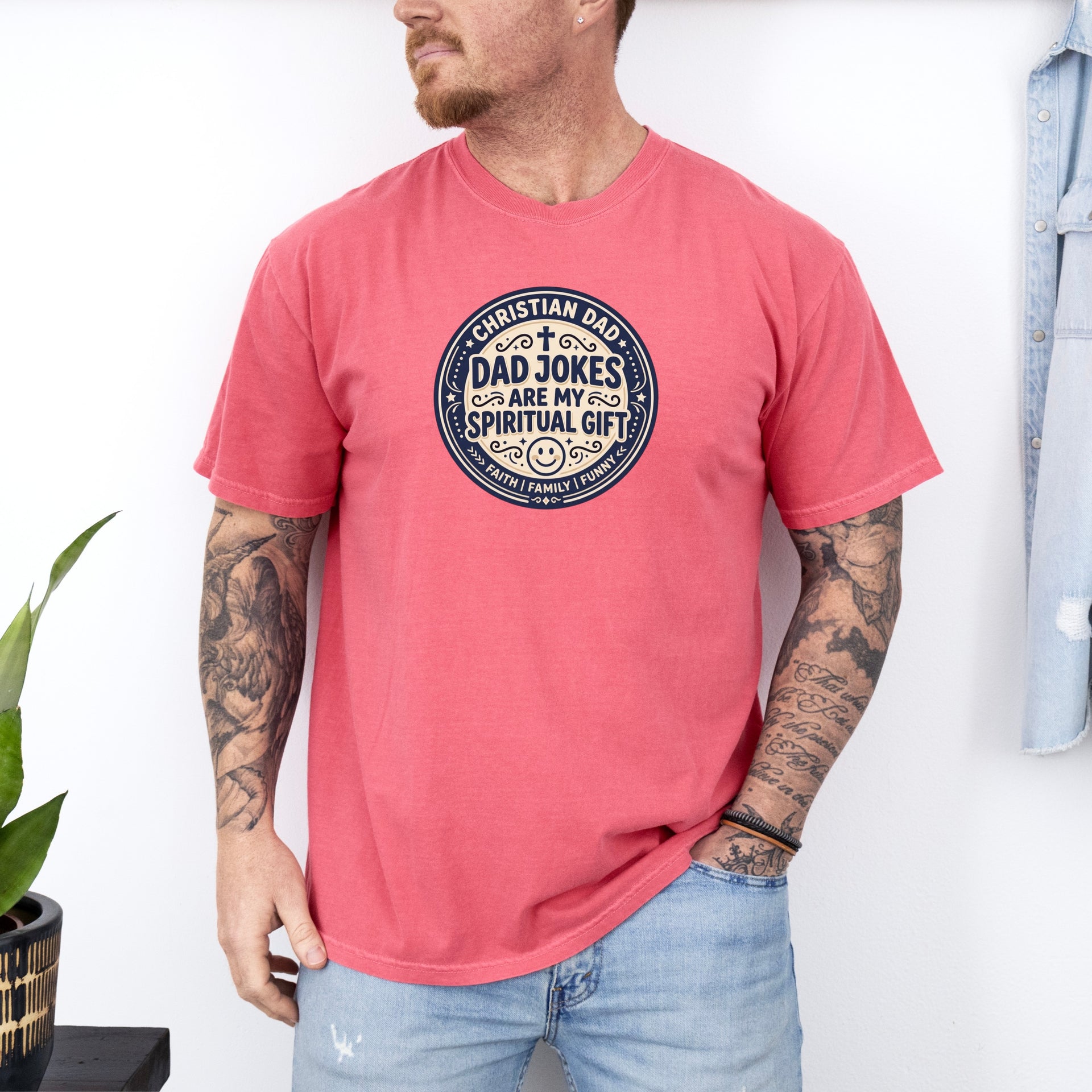 Man wearing a Christian Dad Jokes T Shirt in coral color, showcasing faith and humor together.