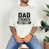 Dad Strength God First T-Shirt worn by a man, featuring bold graphic text, ideal for faith-based casual wear.