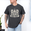 Man wearing Dad Strength God First T-Shirt, showcasing a faith-inspired graphic tee in casual setting.