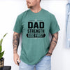 Man wearing Dad Strength God First T-Shirt in green, showcasing a Christian graphic design.